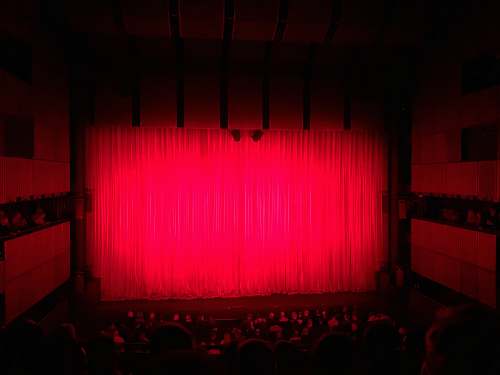 indoors people sitting on theater seat room